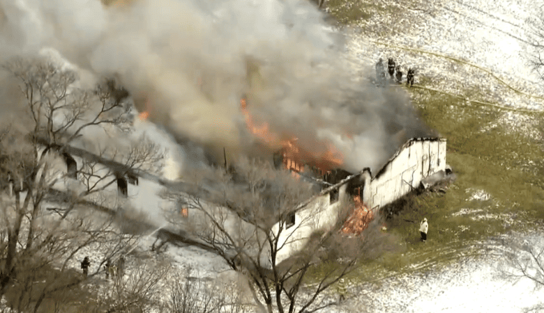 Intense flames from a suburban Chicago church fire engulfing the roof.
