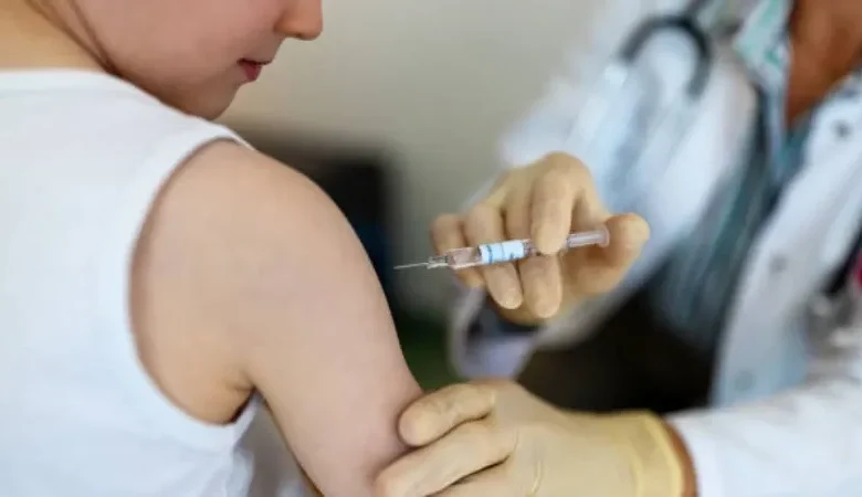 A healthcare worker administering a flu vaccine to a young child.