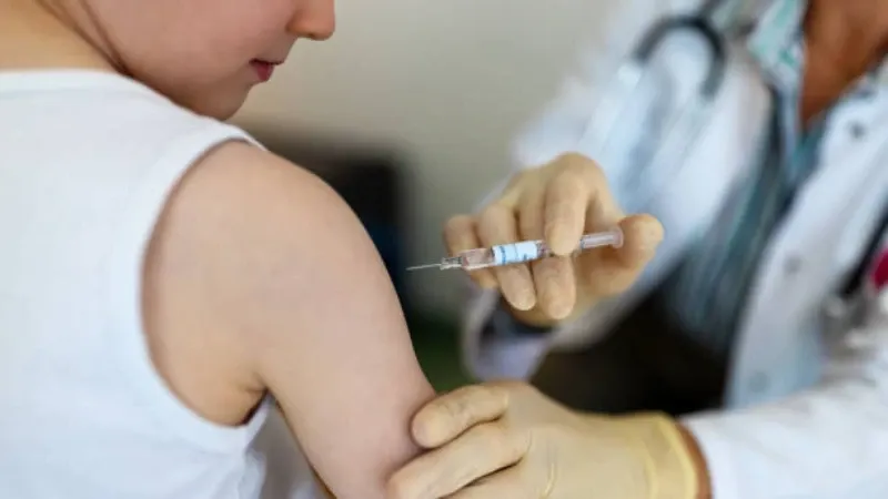 A healthcare worker administering a flu vaccine to a young child.