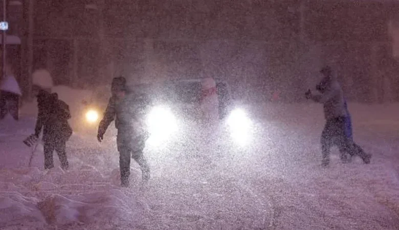 A weather satellite map showing a large blue-and-white storm front approaching the California coast.