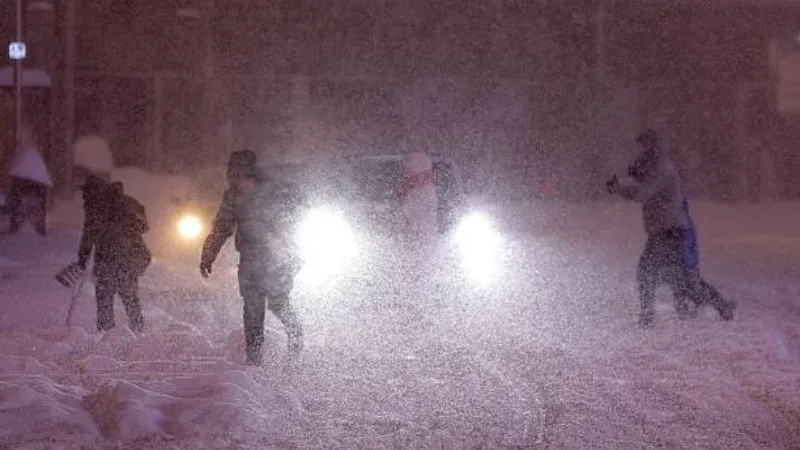 A weather satellite map showing a large blue-and-white storm front approaching the California coast.
