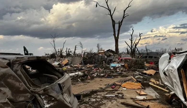 Heavy debris blocks rural roads following the destructive Michigan tornado outbreak.