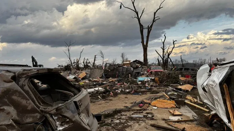 Heavy debris blocks rural roads following the destructive Michigan tornado outbreak.