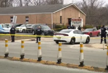 Detectives investigate the street after a deadly Indianapolis church shooting.