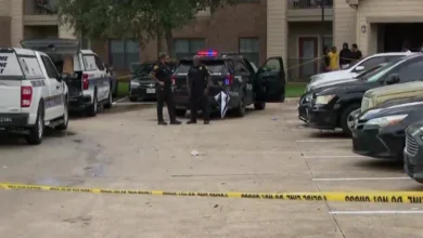 An HPD patrol car with blue and red lights flashing at a cordoned-off intersection in Southwest Houston.