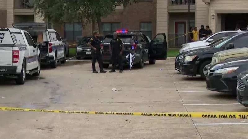 An HPD patrol car with blue and red lights flashing at a cordoned-off intersection in Southwest Houston.