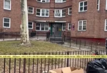 Police tape blocks a hallway during the ongoing Morrisania apartment shooting investigation.