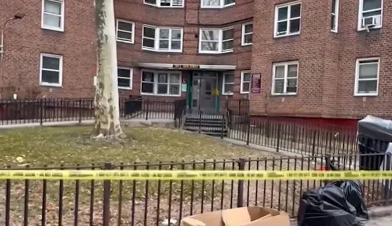 Police tape blocks a hallway during the ongoing Morrisania apartment shooting investigation.