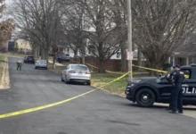 Crime scene tape securing the perimeter after a Normal off-campus shooting.