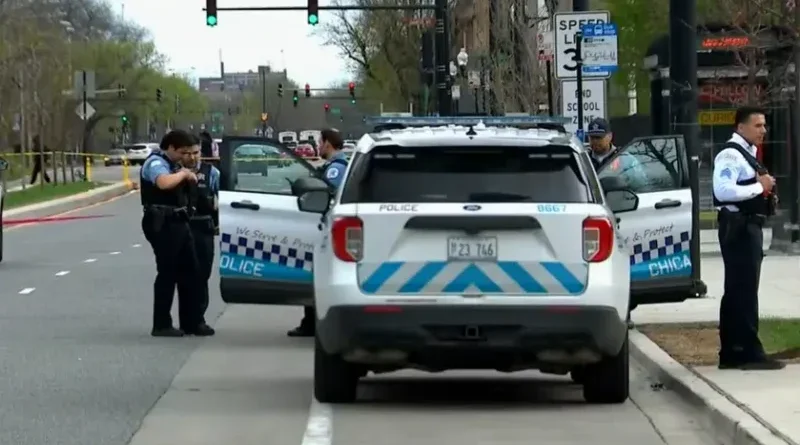 Chicago Police vehicles and crime scene tape near a bus stop on South Stony Island Avenue.
