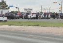 A police vehicle on a highway in Midland, Texas, with emergency lights flashing.