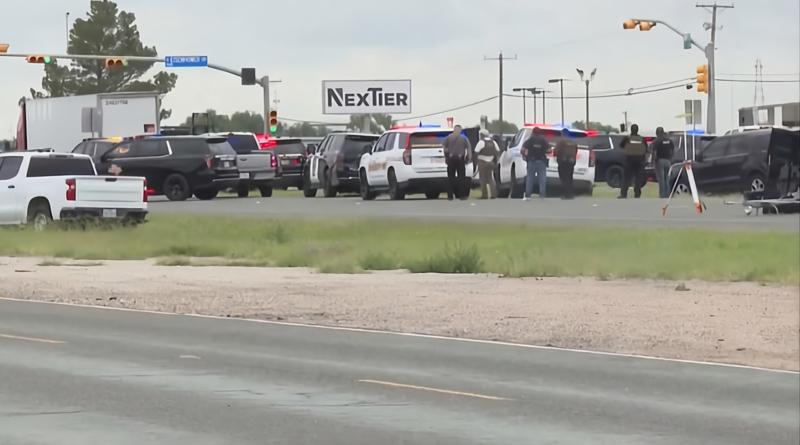 A police vehicle on a highway in Midland, Texas, with emergency lights flashing.
